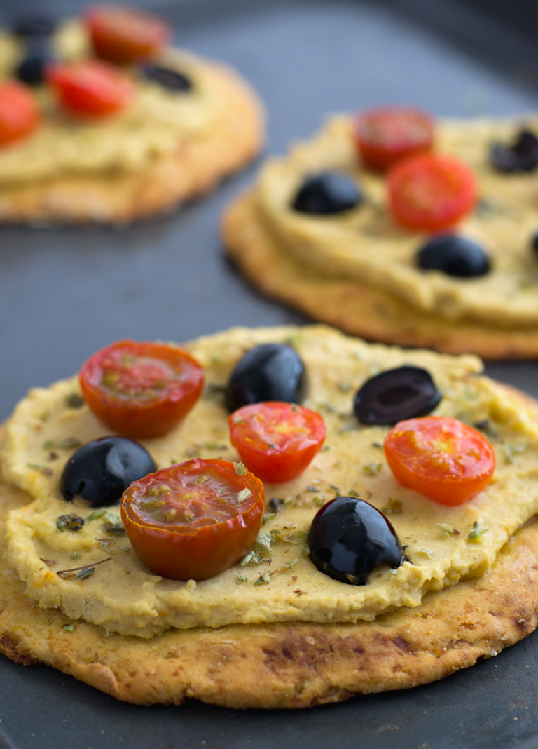 Black olives, cherry tomatoes and hummus pizza