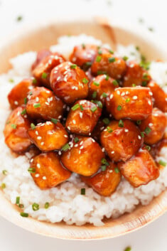 Photo of a bowl of general tso's tofu served over some rice
