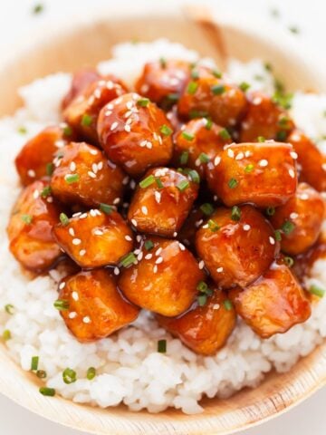 Photo of a bowl of general tso's tofu served over some rice