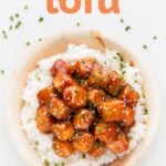 A picture of a dish with general Tso's tofu on white rice
