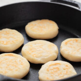 Close-up picture of 6 arepas on a pan
