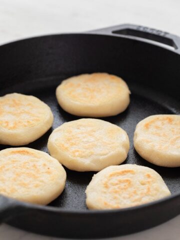 Close-up picture of 6 arepas on a pan