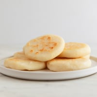 Square photo of arepas on a plate
