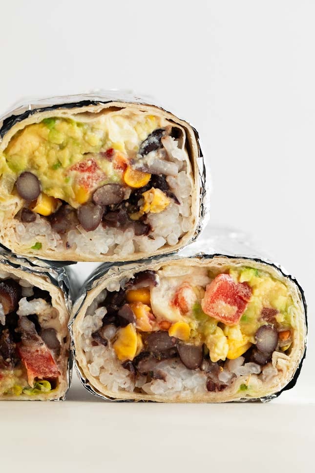 Photo of a pile of 3 vegan burritos cut in half