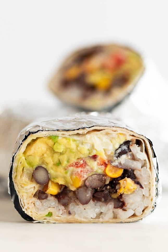 Close-up shot of a vegan burrito cut in half