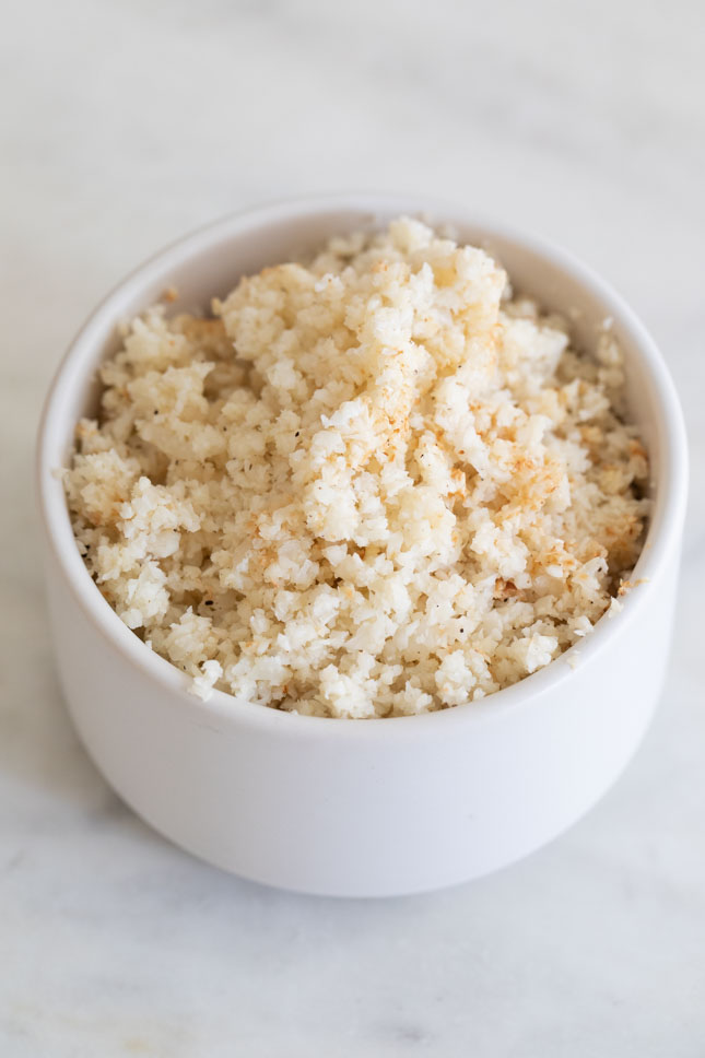A picture of a small bowl with some cooked cauliflower rice