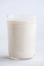 A side shot of a glass jar with vegan buttermilk