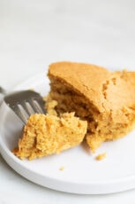 A close shot of a dish with some vegan cornbread and a fork