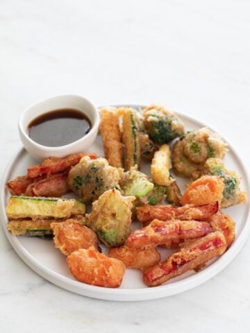 Photo of a plate of vegetable tempura and a small bowl with soy sauce