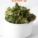 Side shot of a bowl of kale chips with the words kale chips