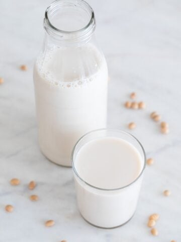 A picture of a bottle and a glass with soy milk made from scratch