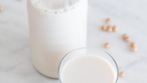 A picture of a bottle and a glass with soy milk made from scratch
