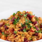 Picture of a dish with homemade vegan jambalaya topped with chopped parsley
