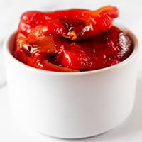 Square photo of a bowl of roasted red peppers