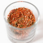 Square photo of a glass jar of chicken seasoning