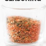Side shot of a glass jar of chicken seasoning with the words chicken seasoning