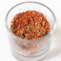 Square photo of a glass jar of chicken seasoning