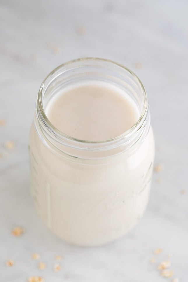 A picture of a Mason jar filled with oat milk