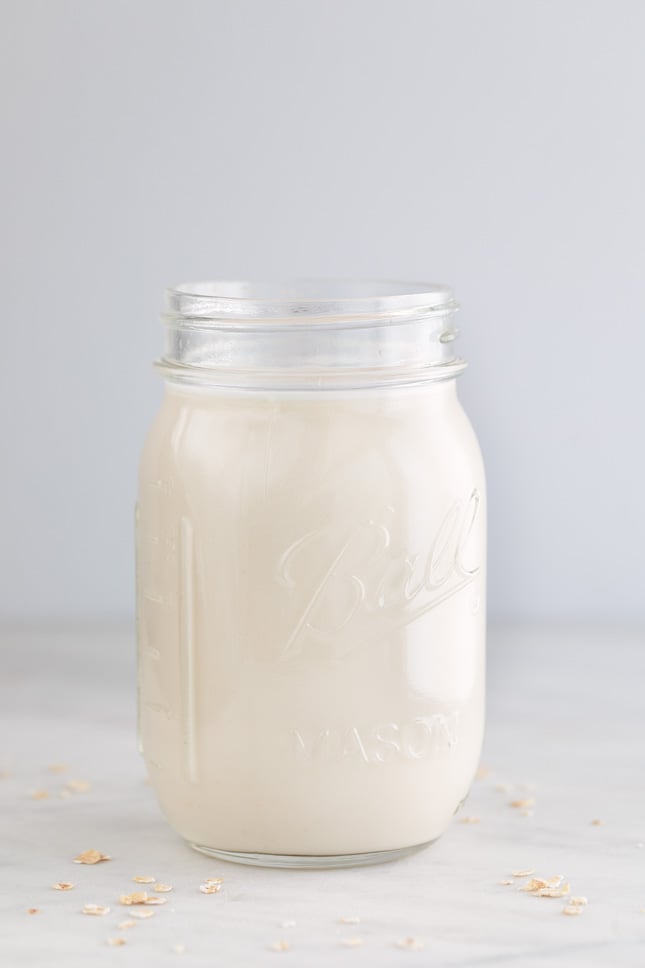 A side shot of a glass jar with homemade oat milk