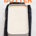 A container with some homemade vegan butter onto a white surface with the words vegan butter
