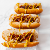 Square photo of 3 vegan hot dogs