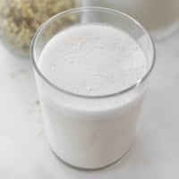 Square photo of a glass of hemp milk