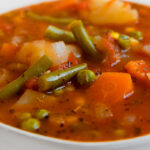 Close-up picture of vegetable soup with the words vegetable soup