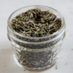 A square picture of a glass jar with homemade Italian seasoning
