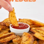 Photo of a potato wedge being dipped in ketchup with the words potato wedges