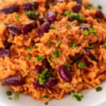 Square photo of a plate of Spanish rice and beans