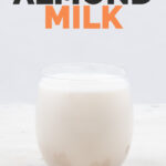 Side shot of a glass of almond milk with the words almond milk