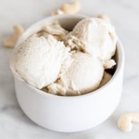 Square photo of a bowl with 3 servings of vegan ice cream in it