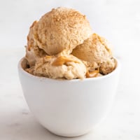 Square photo of a bowl with 2 scoops of banana ice cream