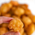 Close-up photo of a piece of fried cauliflower with the words fried cauliflower