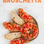Photo of a wooden plate of bruschetta with the words how to make bruschetta
