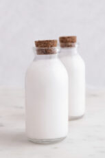 Photo of 2 glass bottles of homemade coconut milk