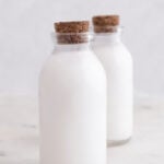 Photo of 2 bottles of homemade coconut milk with the words how to make coconut milk
