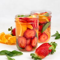 Square photo of 2 glass jars of fruit infused water