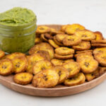 Square photo of a plate of plantain chips with some