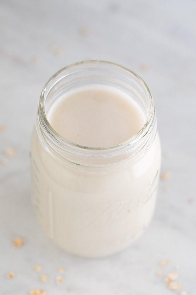 Photo of a glass jar of oat milk