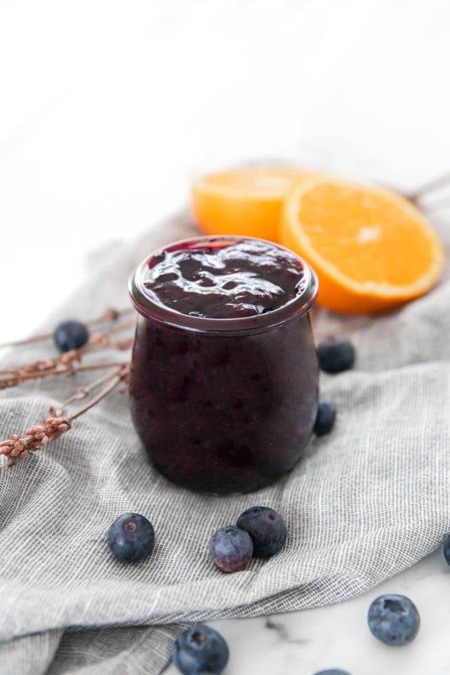 Photo of a small glass jar of blueberry compote