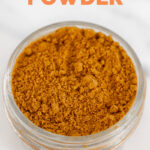 Photo of a small glass jar of curry powder with the words curry powder