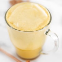 Square photo of a cup of turmeric latte