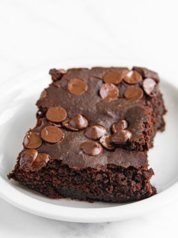 Photo of a piece of black bean brownies with vegan chocolate chips on top