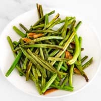 Square photo of a plate of garlic green beans