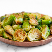 Square photo of a plate of sauteed Brussels sprouts
