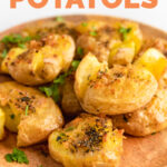 Close-up shot of a plate of smashed potatoes with the words smashed potatoes