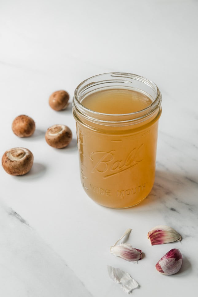 Photo of a glass jar of vegetable stock