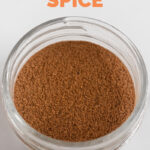 Close-up shot of a glass jar of pumpkin pie spice with the words pumpkin pie spice