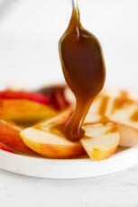 Photo of a spoonful of vegan caramel over some sliced apples